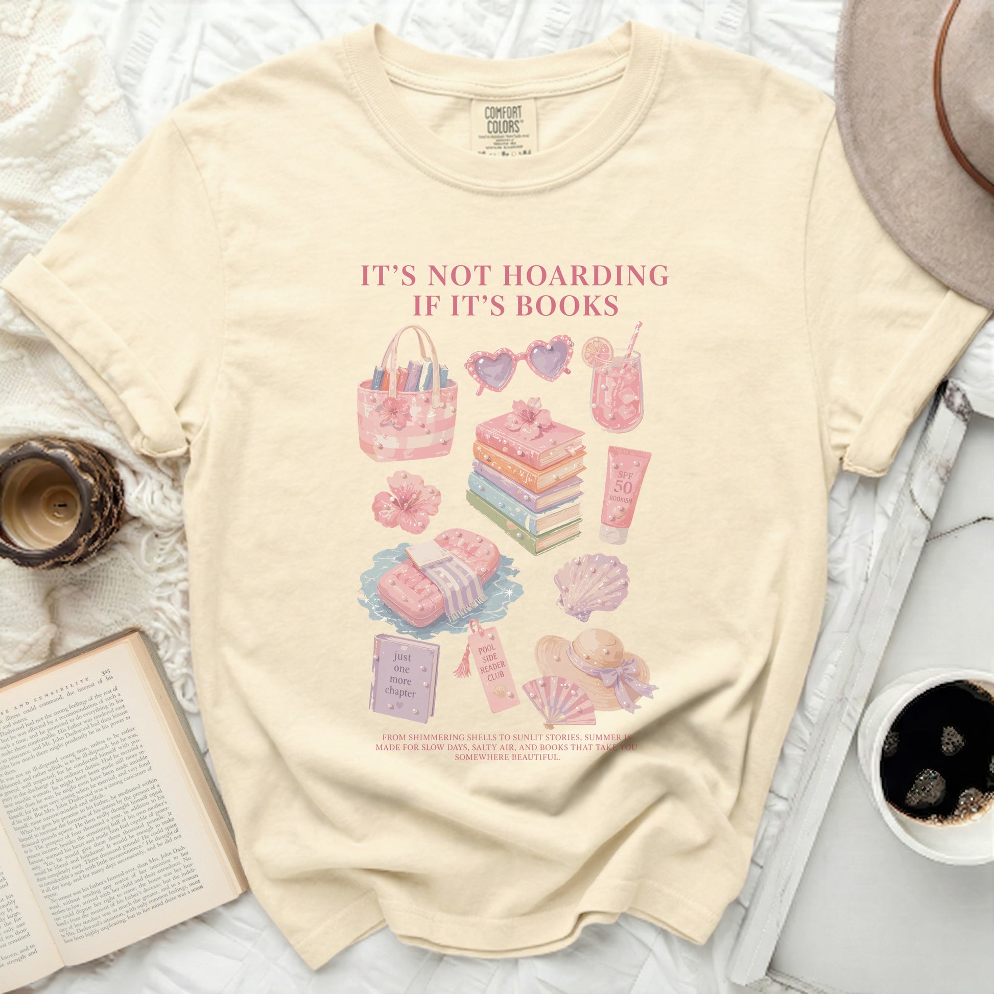 Cream t-shirt with "It's Not Hoarding If It's Books" and beachy graphics.