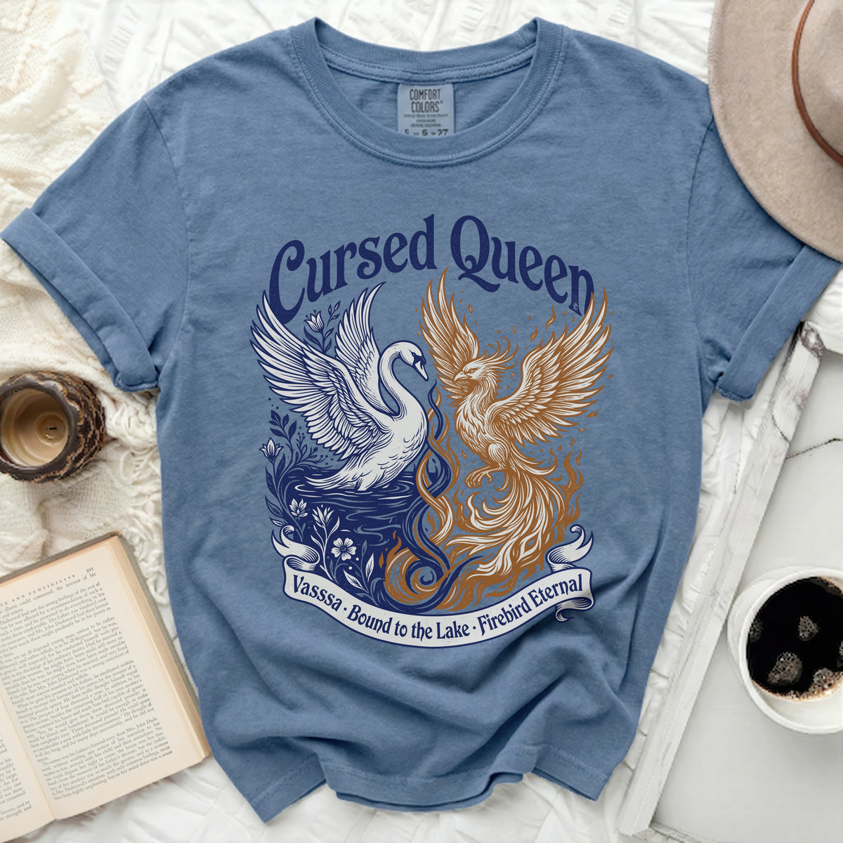 Blue t-shirt with "Cursed Queen" text and swan and phoenix design.