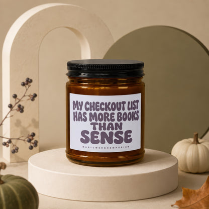 Amber jar candle with "My checkout list has more books than sense" text.
