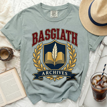 Light blue t-shirt with "Basgiath Archives" crest and open book graphic.