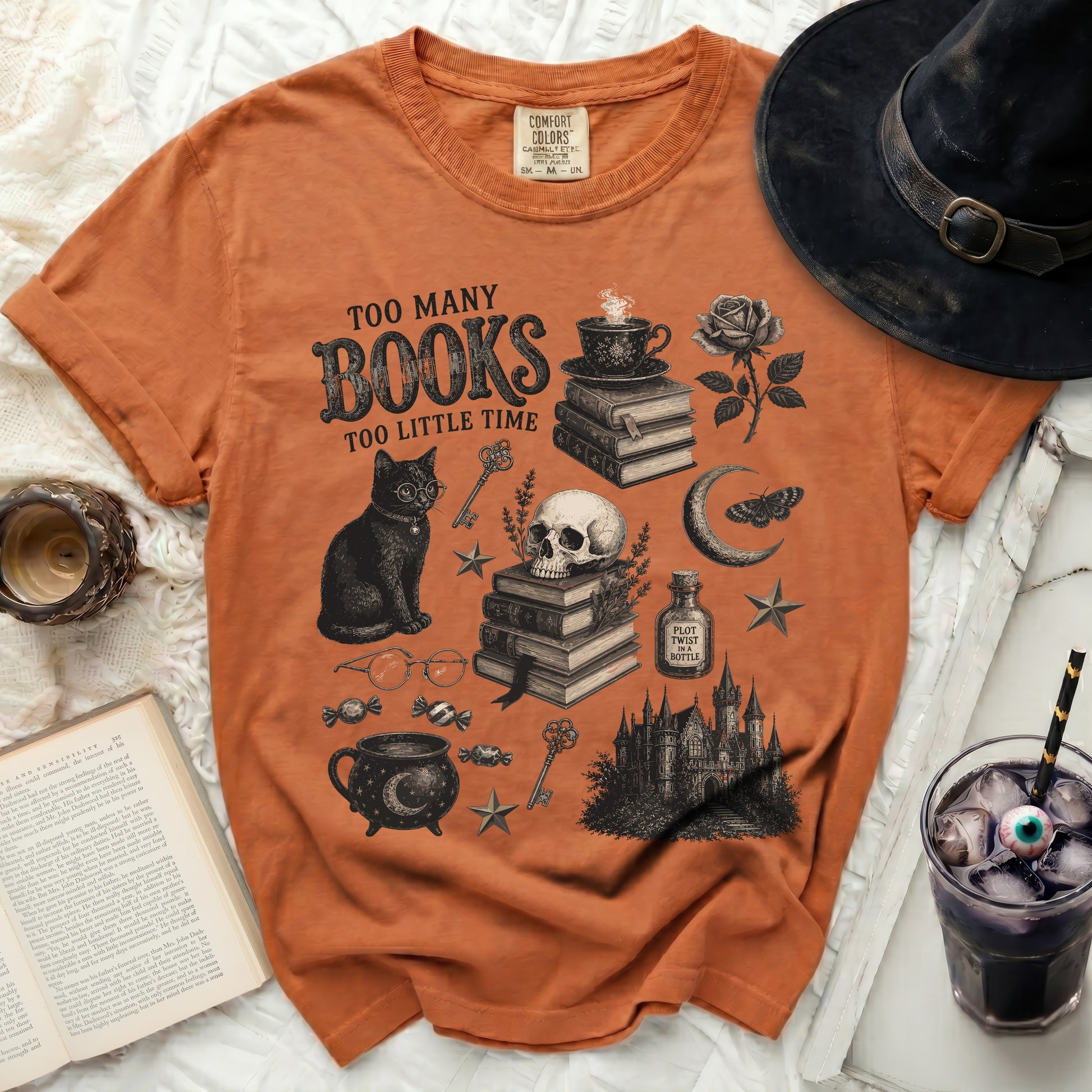 Orange t-shirt with "Too Many Books Too Little Time" graphic, black cat, skull, and gothic castle.