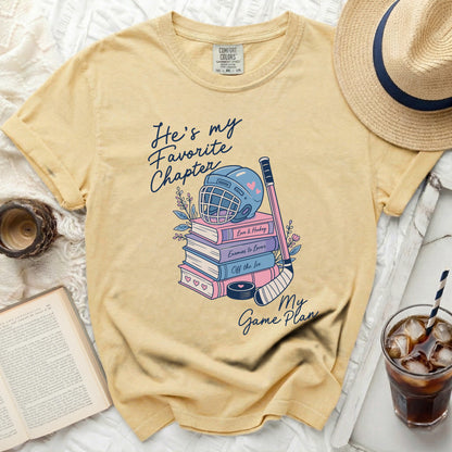 Yellow t-shirt with "He's my Favorite Chapter" and book-themed hockey graphics.