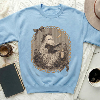 Light blue sweatshirt with a lace ghost reading a book design.