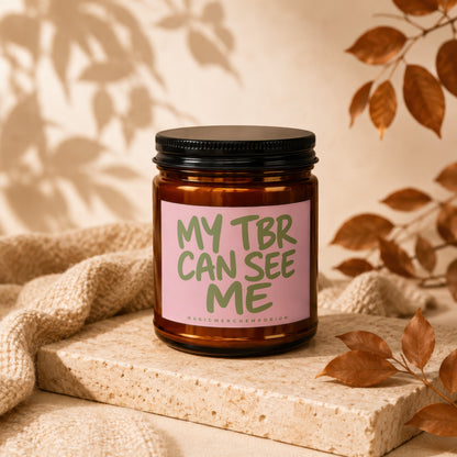 Candle with pink label reading "MY TBR CAN SEE ME".