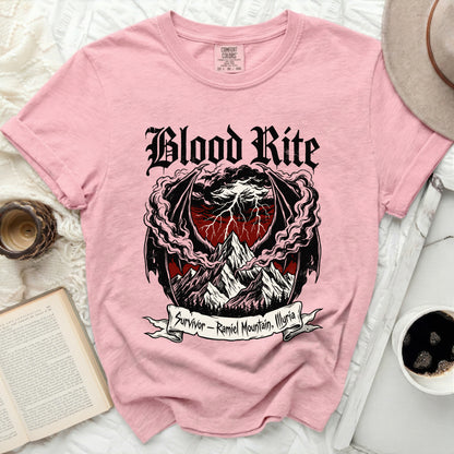Pink t-shirt with "Blood Rite" and "Survivor - Ramiel Mountain, Illyria" design.