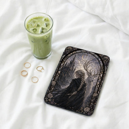 Cover art with stained glass design of a woman and a deer next to a glass of matcha tea.