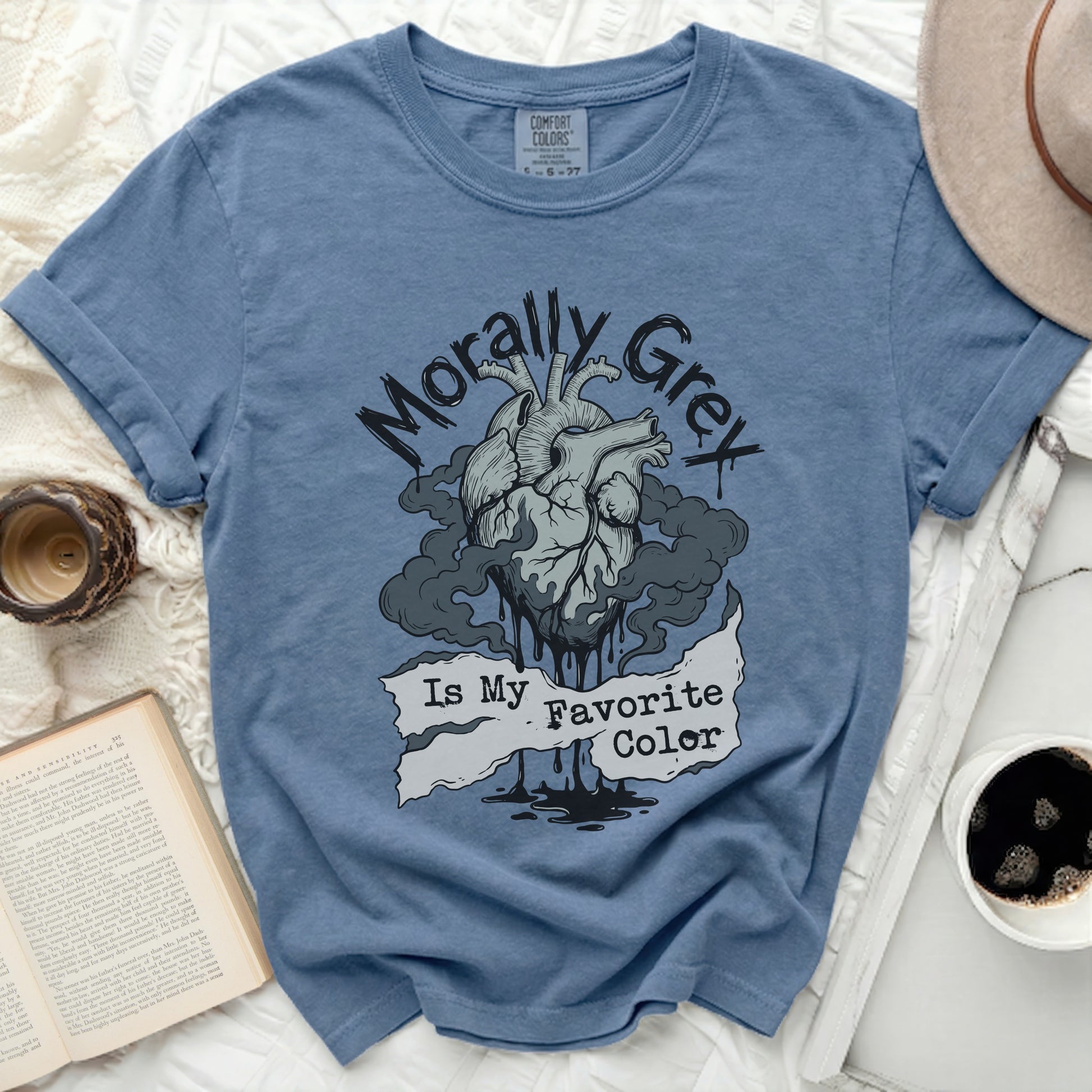 Blue t-shirt with graphic of a heart surrounded by smoke and text "Morally Grey Is My Favorite Color".