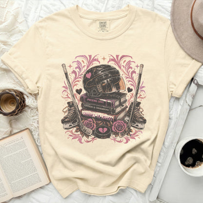 Cream t-shirt with hockey gear, books, and "Pucking Love" text.