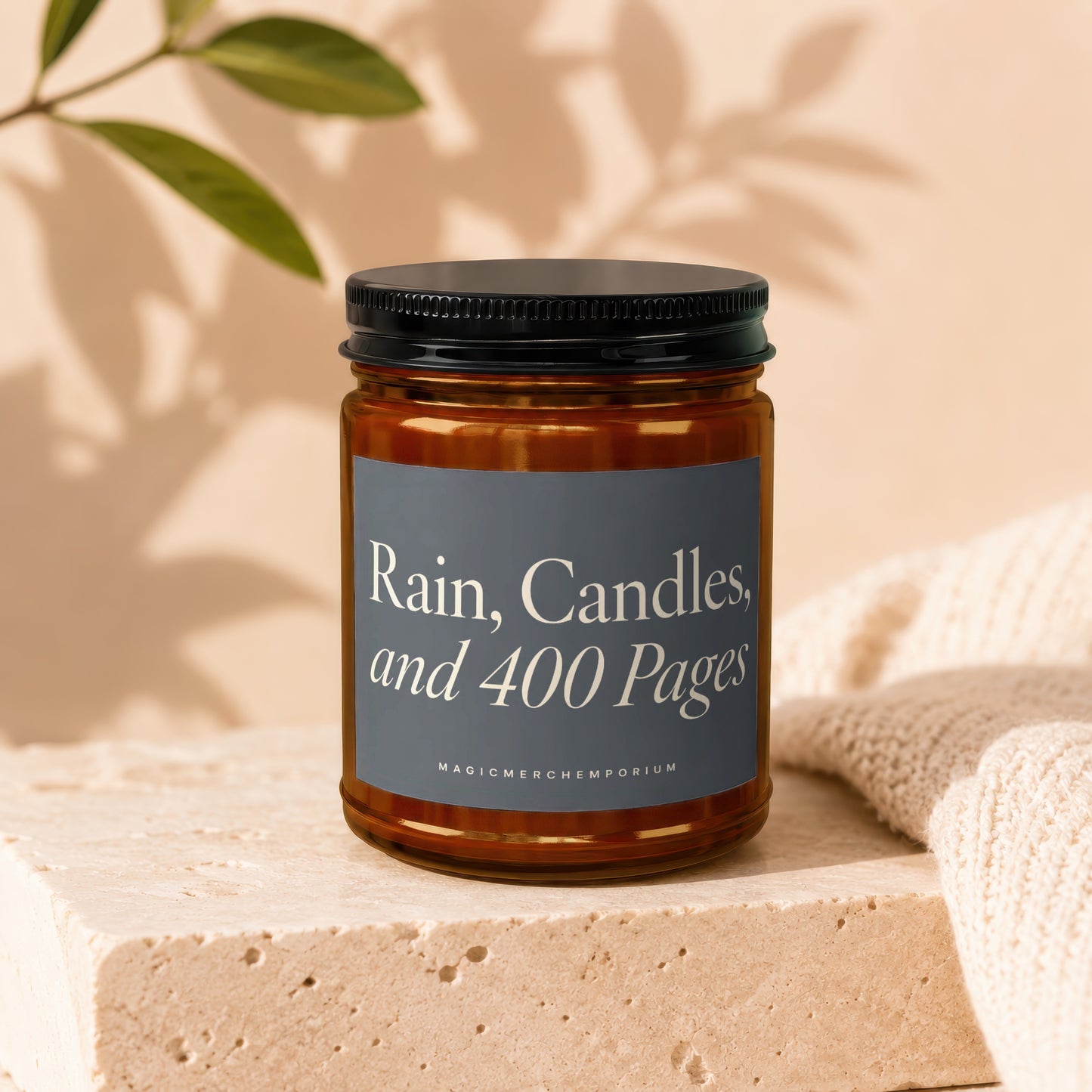 Candle with label "Rain, Candles, and 400 Pages" and "MagicMerchemporium."