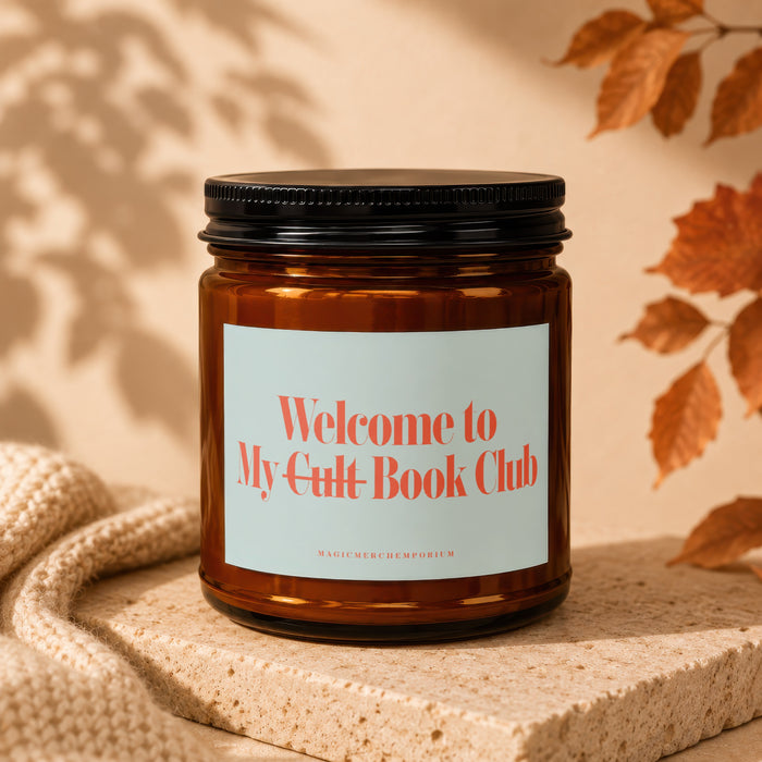Amber candle with a black lid and label reading "Welcome to My Cult Book Club".