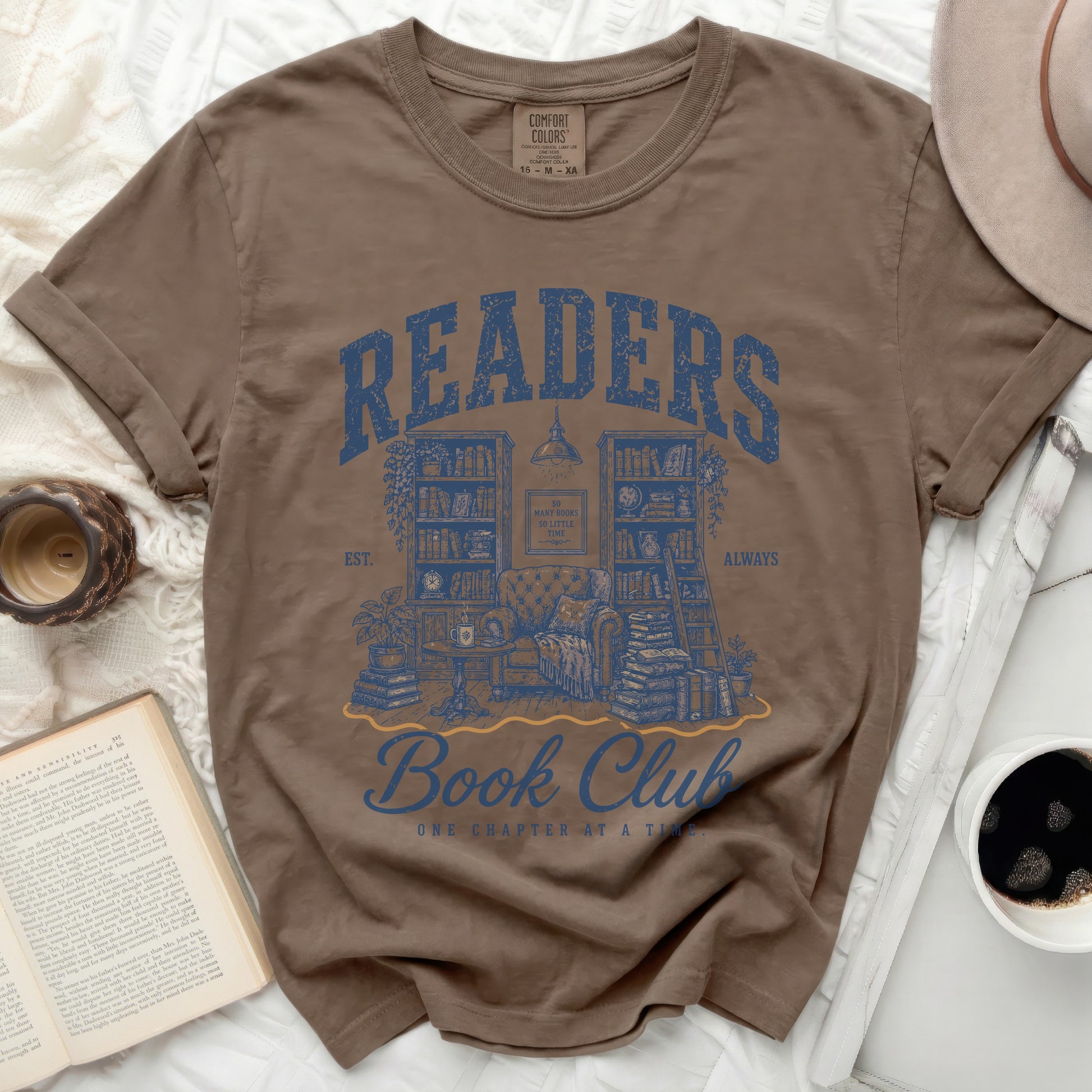 Brown t-shirt with "Readers Book Club" graphic and books.