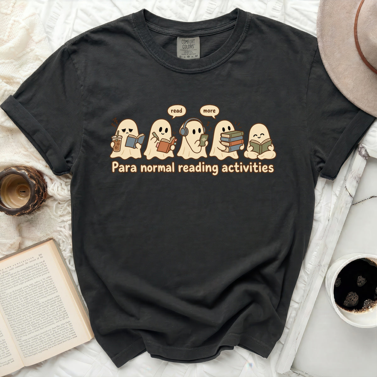 Dark grey t-shirt with ghosts reading and the text "Para normal reading activities".