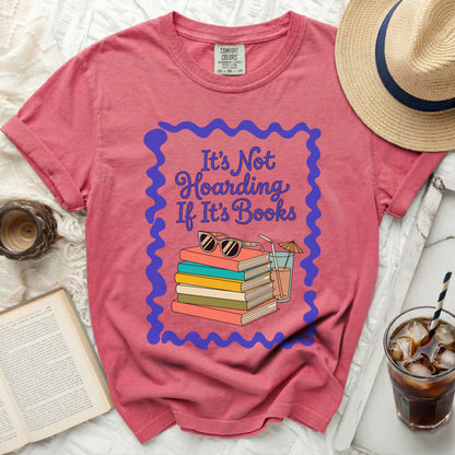 Coral t-shirt with "It's Not Hoarding If It's Books" and stack of books graphic.