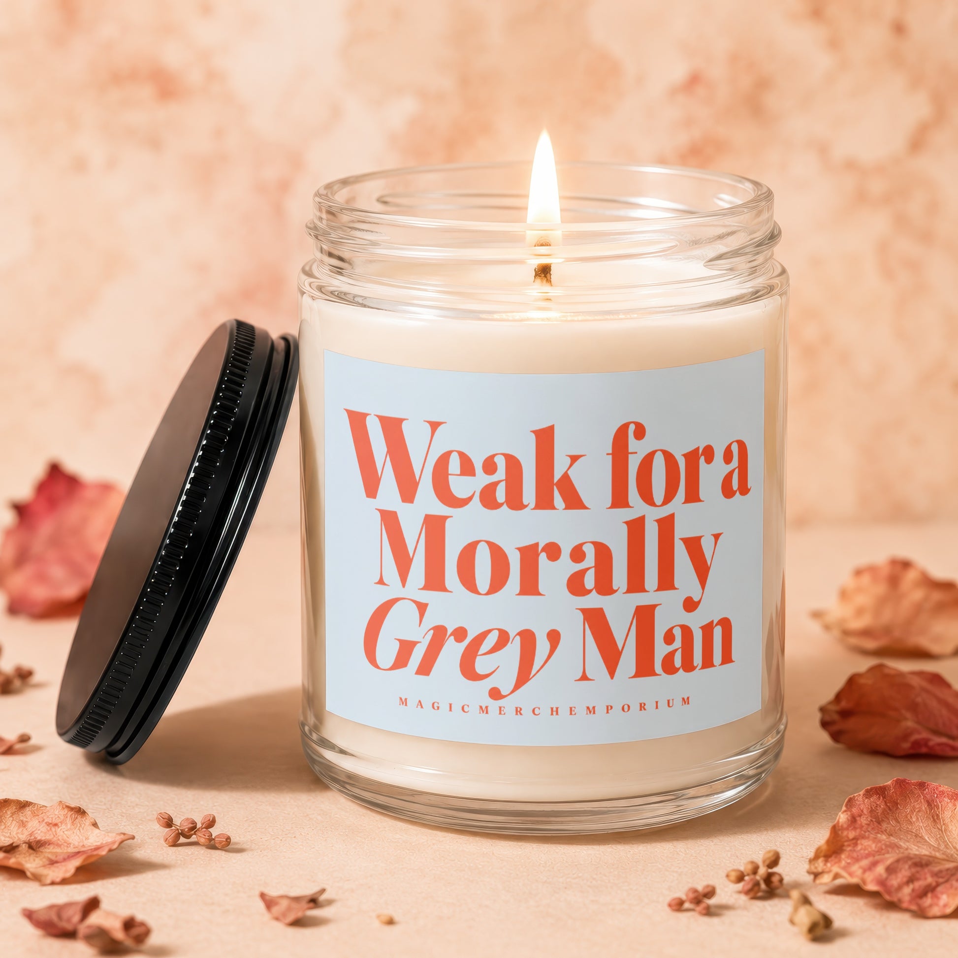 Candle with lit wick and label "Weak for a Morally Grey Man"