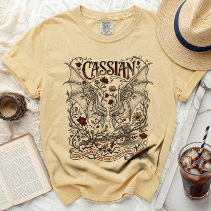 Yellow t-shirt with "Cassian Lord of Bloodshed" graphic and winged motif.