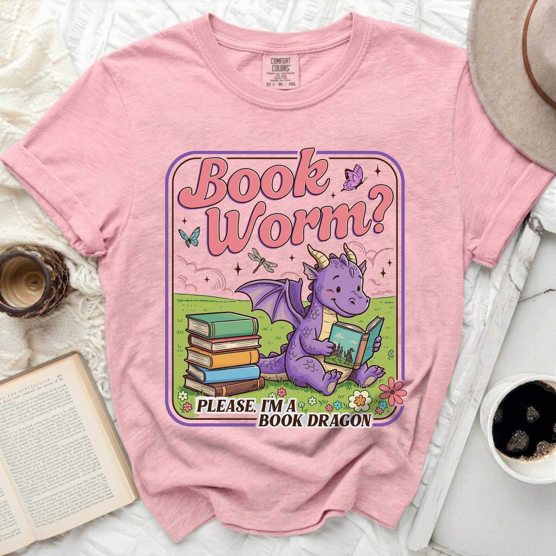 Pink t-shirt with cartoon dragon reading book, "Book Worm?" text.