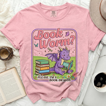 Pink t-shirt with cartoon dragon reading book, "Book Worm?" text.