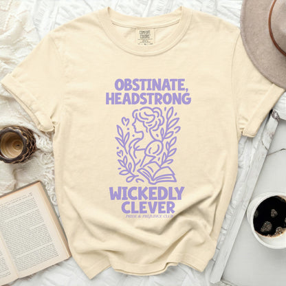 Cream t-shirt with purple text "OBSTINATE, HEADSTRONG WICKEDLY CLEVER".