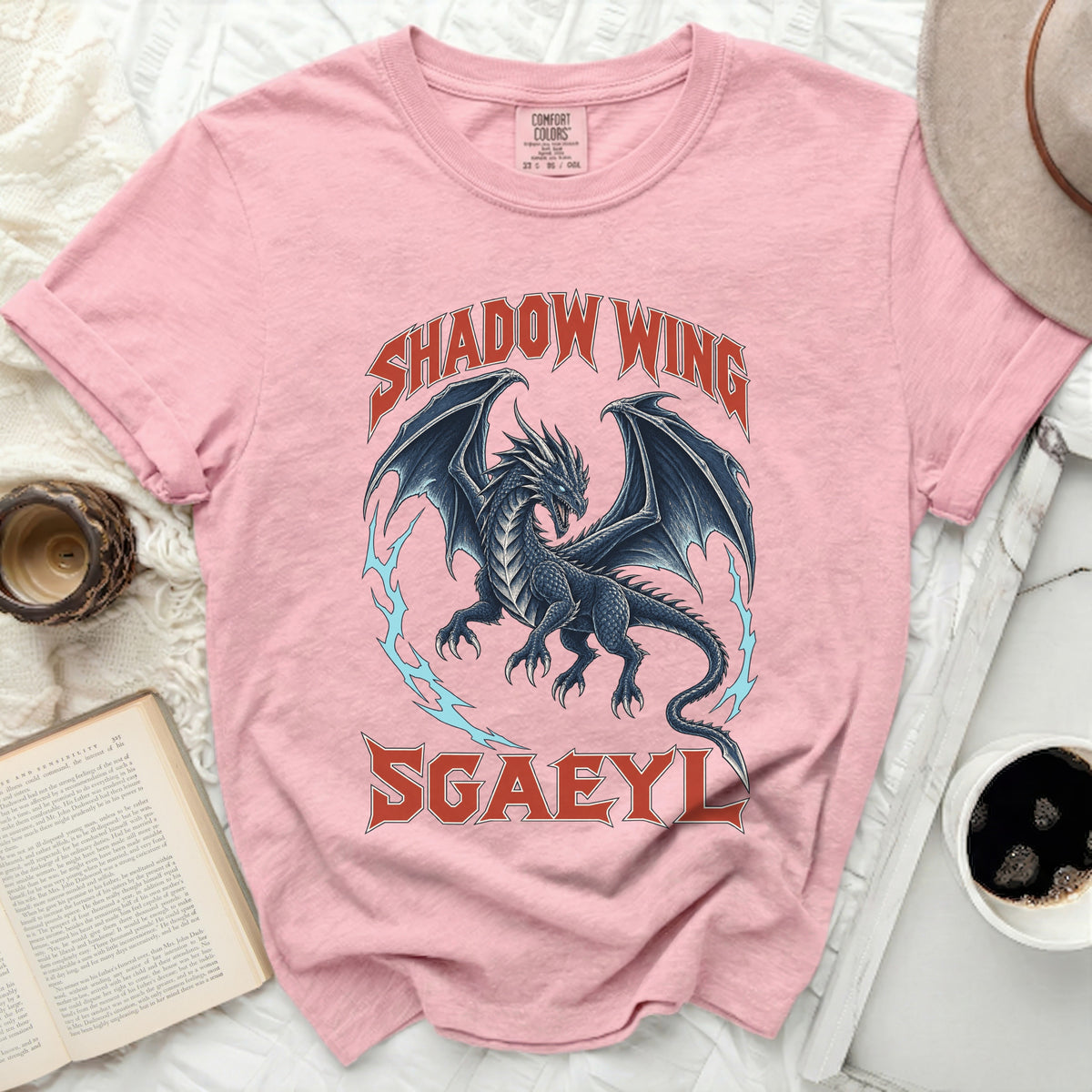 Pink t-shirt with a dark dragon graphic and text "SHADOW WING SGAEYL".