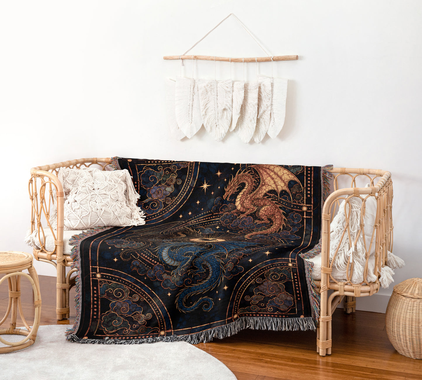 a cozy living space with a black dragon-themed blanket draped over a wicker bench. The bench is adorned with white pillows and a woven basket is placed nearby. A wall hanging with white feathers adds a touch of elegance to the room.