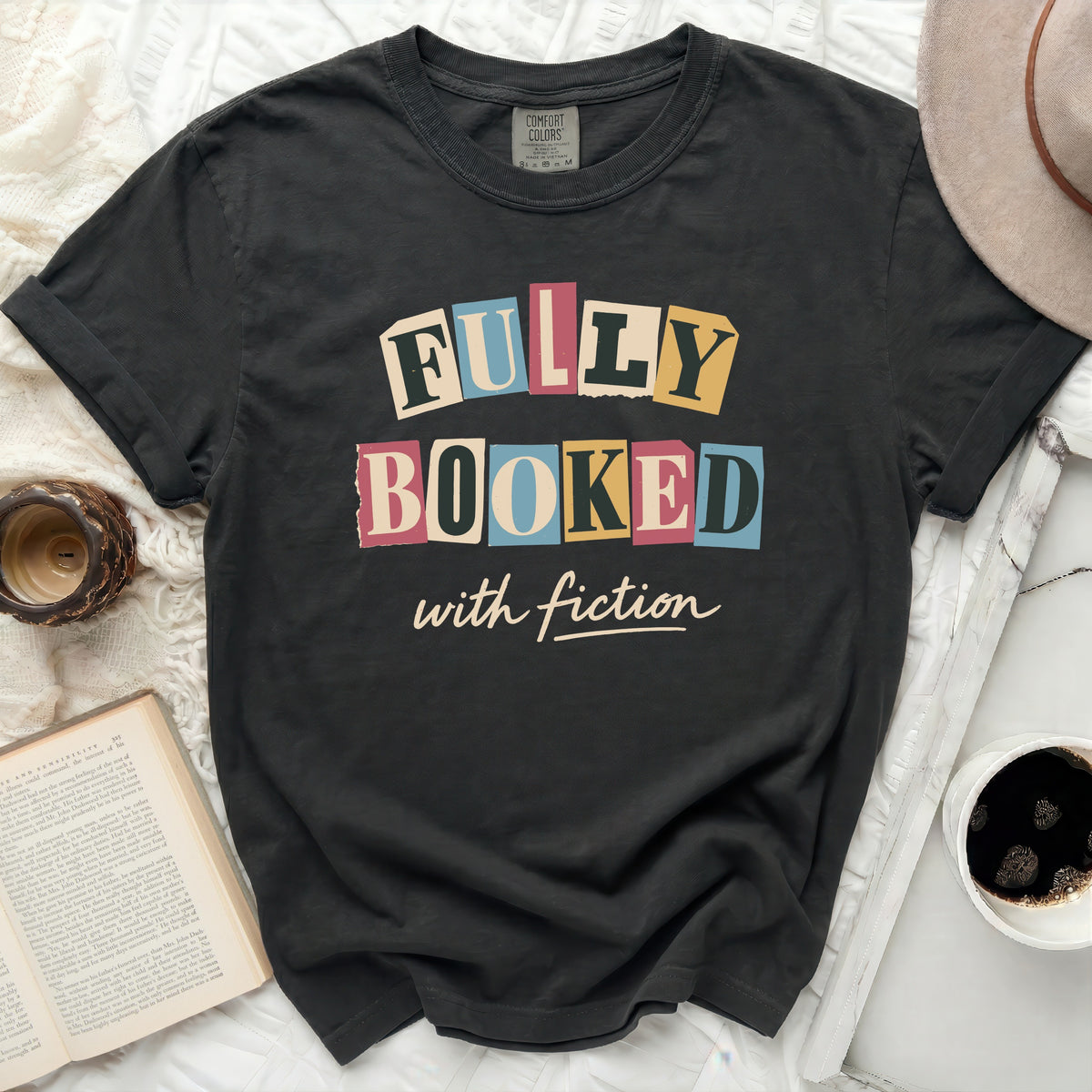 Dark gray t-shirt with "FULLY BOOKED with fiction" in colorful block letters.