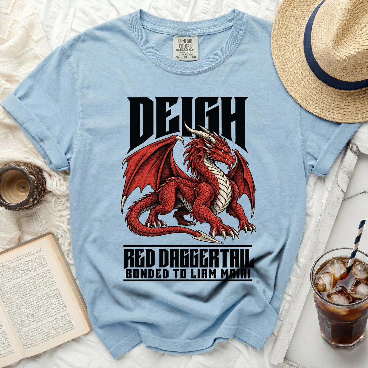 Light blue t-shirt with a red dragon graphic and text "DEIGH RED DAGGERTAIL BONDED TO LIAM MAIRI".
