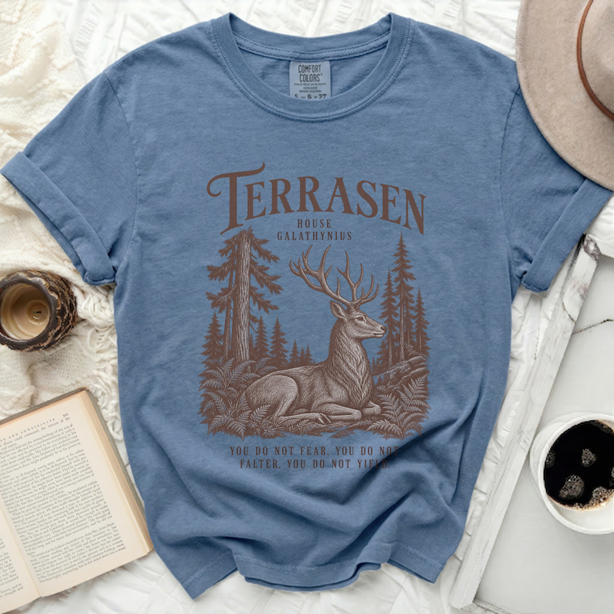 Blue t-shirt with Terrasen House Galathynius deer forest graphic and quote.
