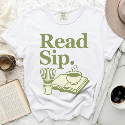 White Comfort Colors t-shirt with green text "Read Sip." and graphics.