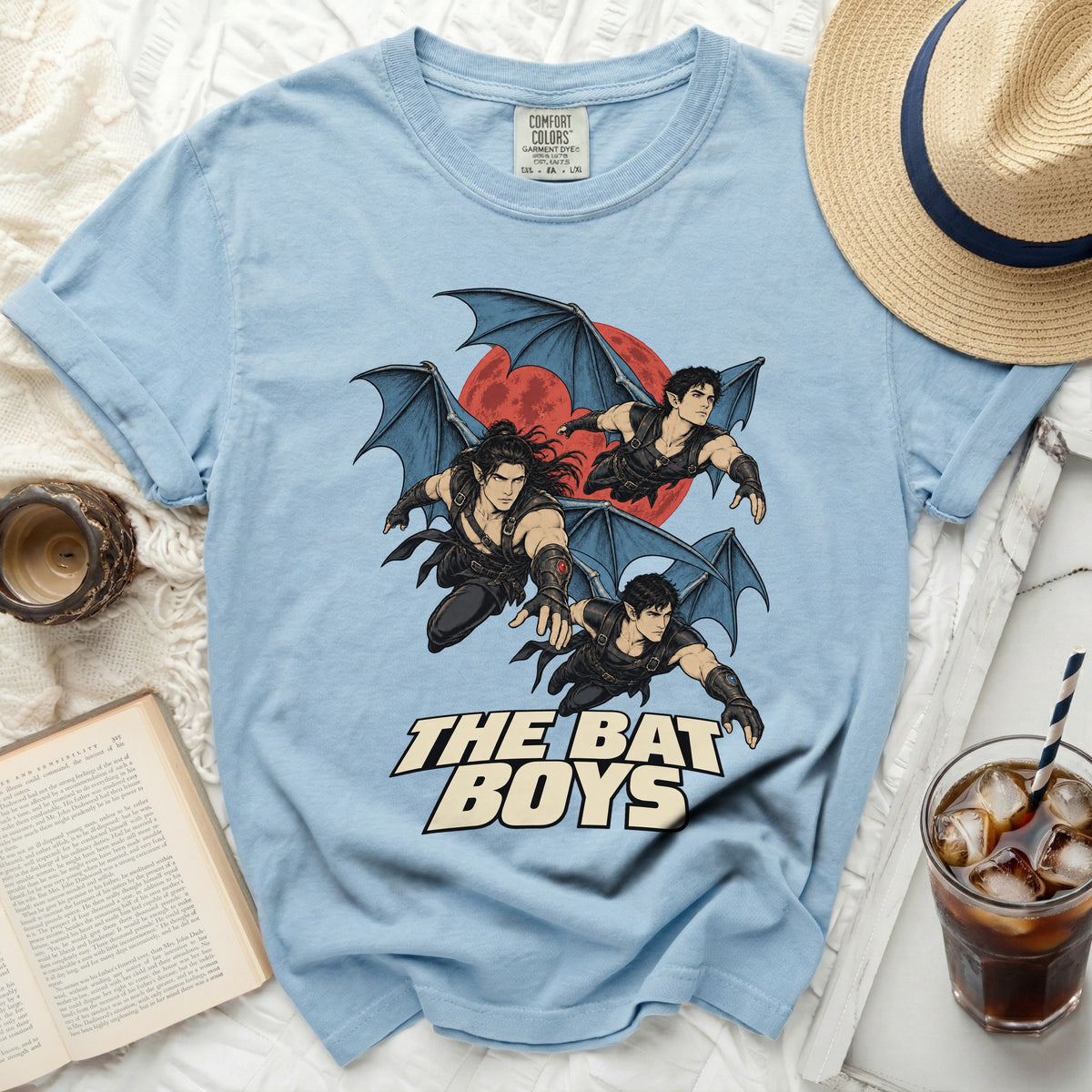 Light blue t-shirt with "The Bat Boys" text and winged figures graphic.