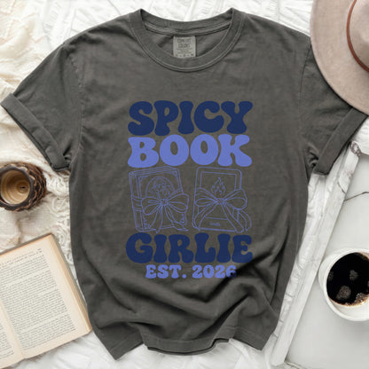 Dark gray t-shirt with "SPICY BOOK GIRLIE EST. 2026" in blue retro font.