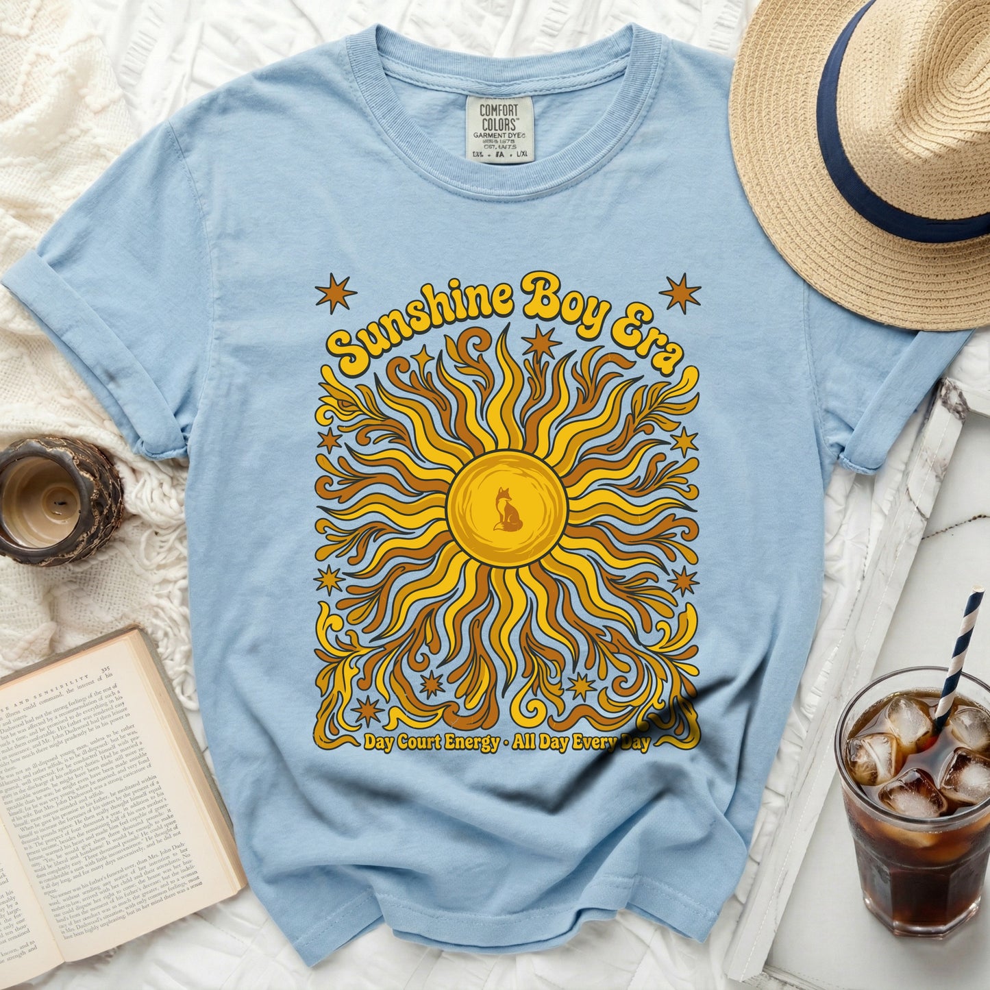 Light blue t-shirt with "Sunshine Boy Era Day Court Energy All Day Every Day" graphic.
