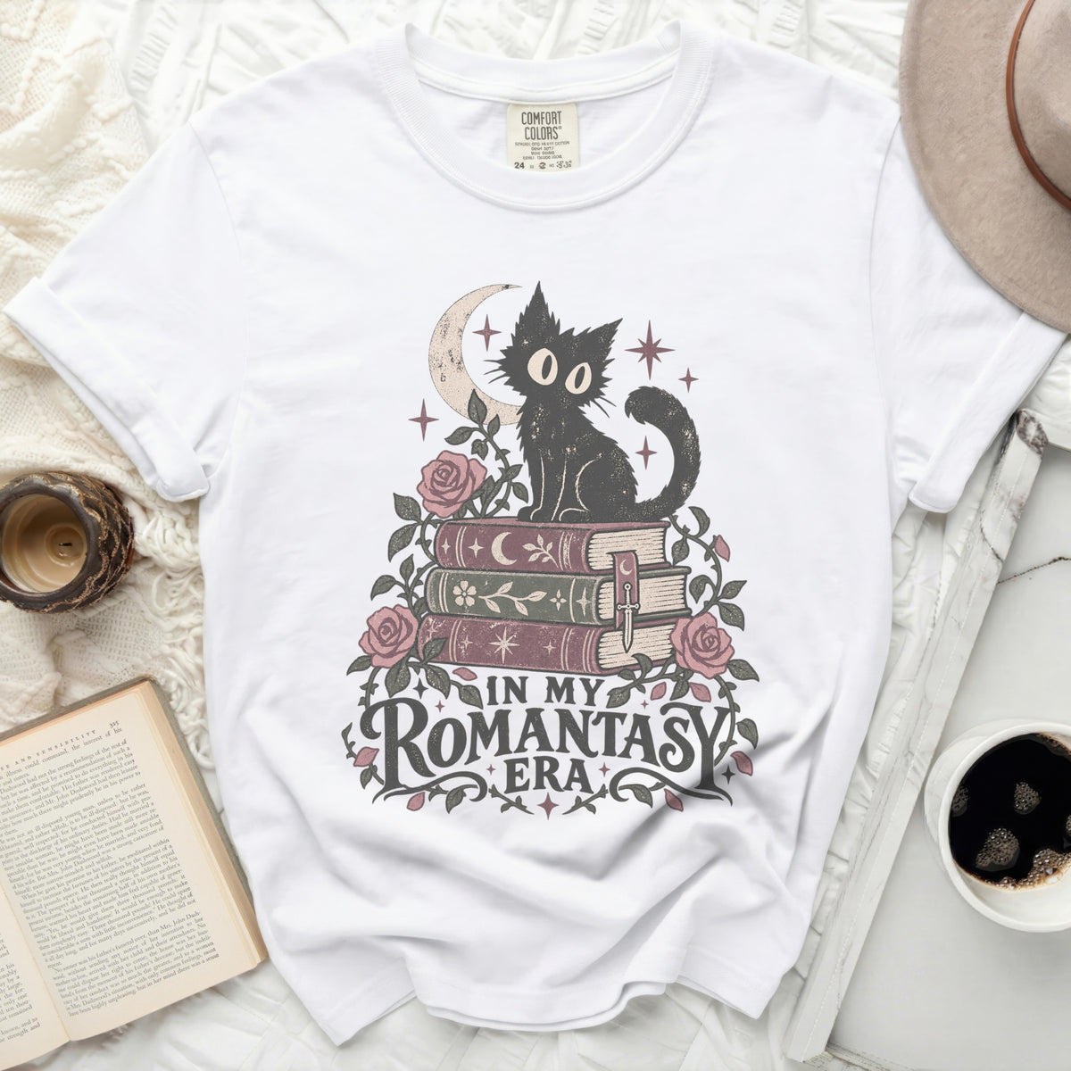 White t-shirt with black cat sitting on books, text reads "In My Romantasy Era".