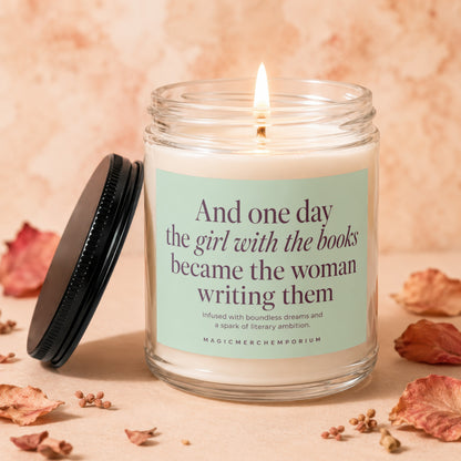 Lit candle with text "And one day the girl with the books became the woman writing them."