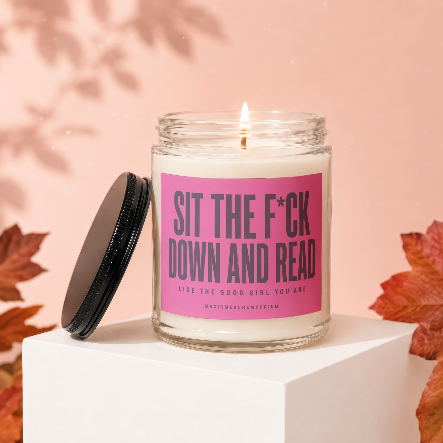 Candle with text "SIT THE F*CK DOWN AND READ LIKE THE GOOD GIRL YOU ARE".