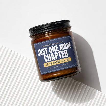 Brown glass candle with navy label reading "Just One More Chapter. It Is Now 2 A.M."