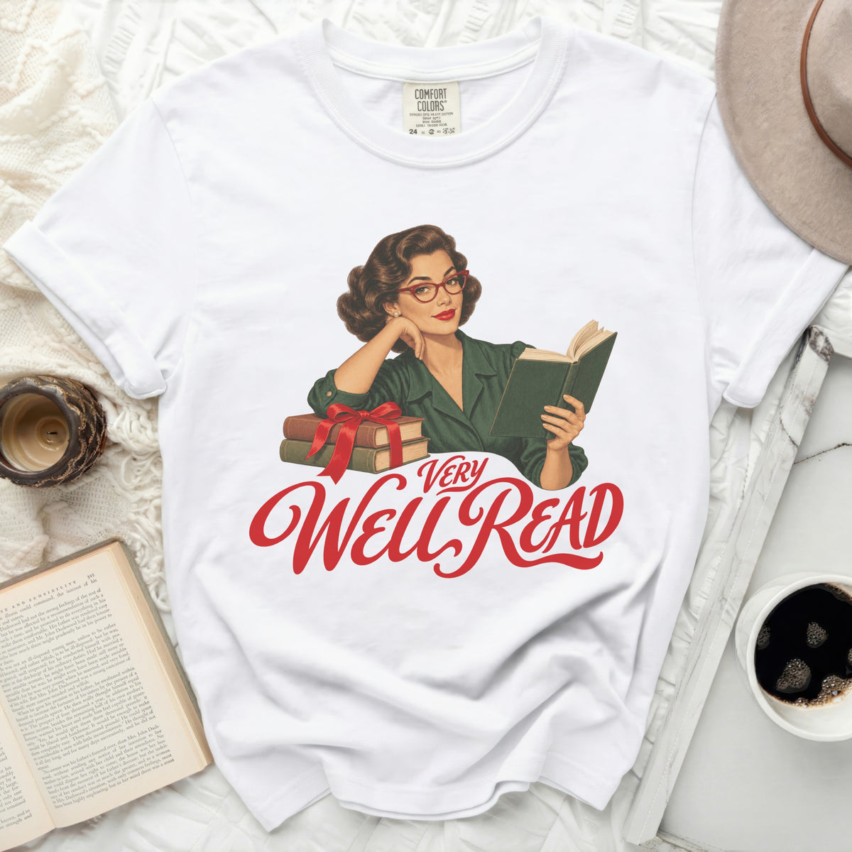 White t-shirt with vintage illustration of woman reading and text "Very Well Read".