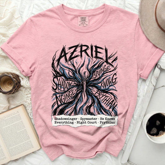 Pink t-shirt with "AZRIEL" and black, blue, and white abstract design with text.