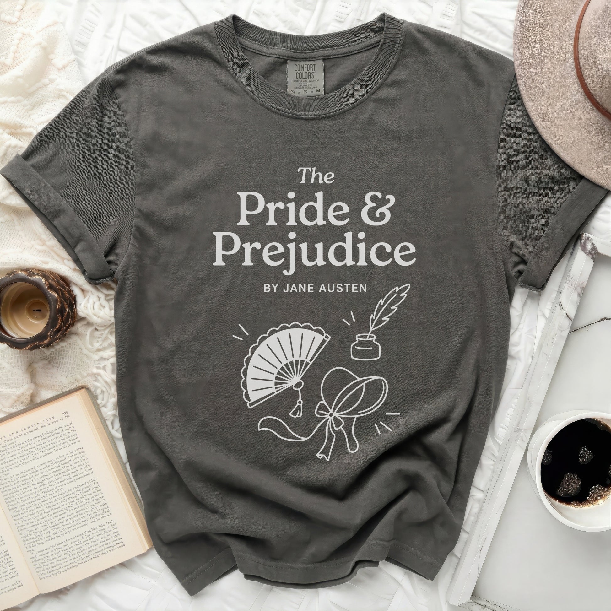 Dark grey t-shirt with "The Pride & Prejudice BY JANE AUSTEN" text and line art.