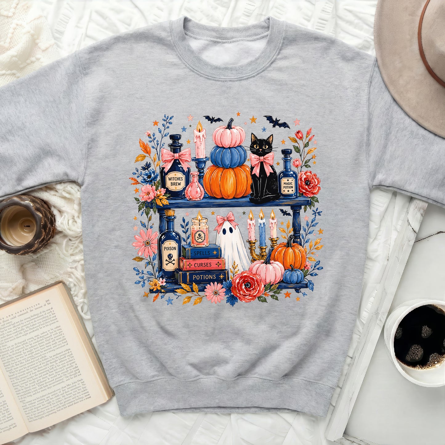Gray sweatshirt with a Halloween-themed graphic of potions, pumpkins, a cat, and a ghost.