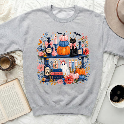 Gray sweatshirt with a Halloween-themed graphic of potions, pumpkins, a cat, and a ghost.