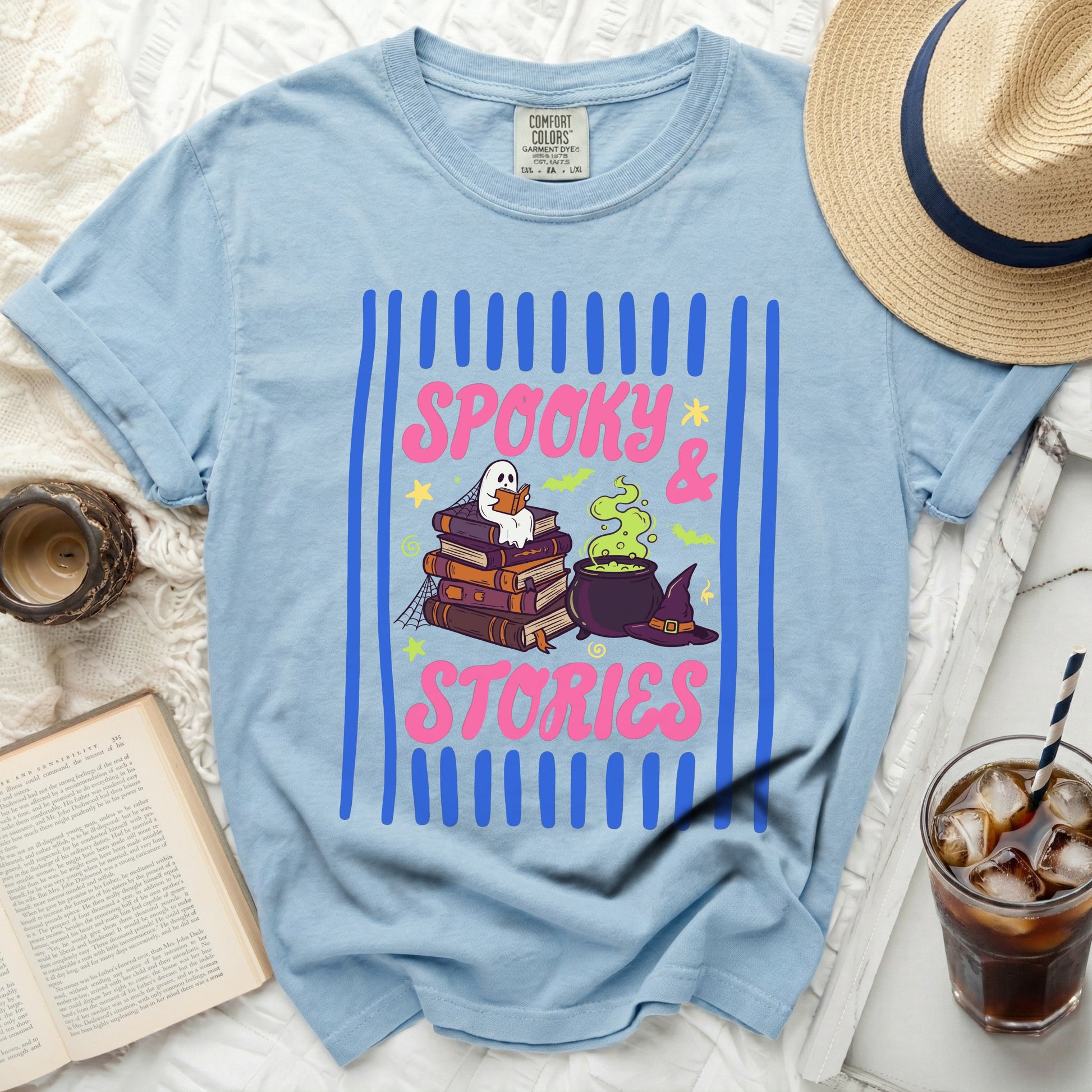 Light blue t-shirt with "Spooky & Stories" graphic of ghost reading books.