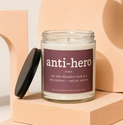 Glass candle with "anti-hero" label and definition.