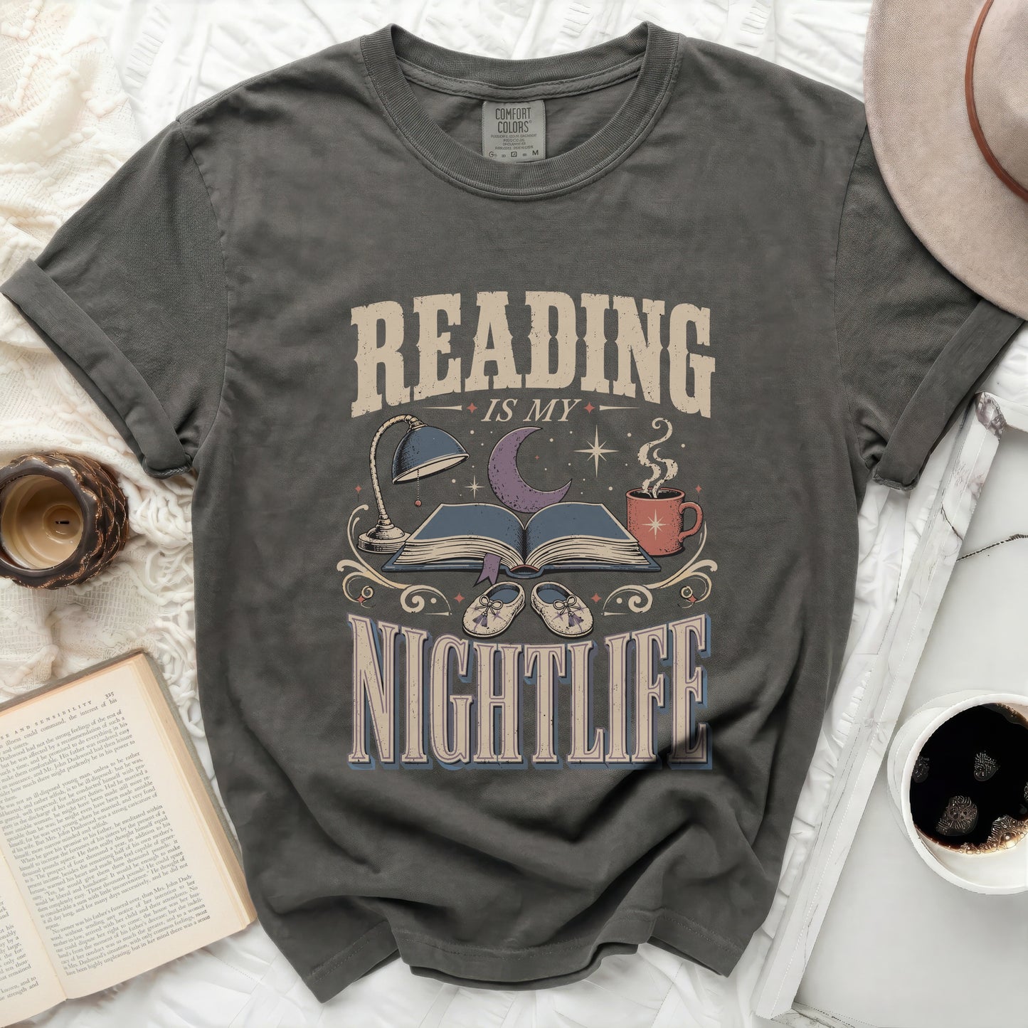 Reading is my nightlife graphic t-shirt with book, lamp, and moon design.
