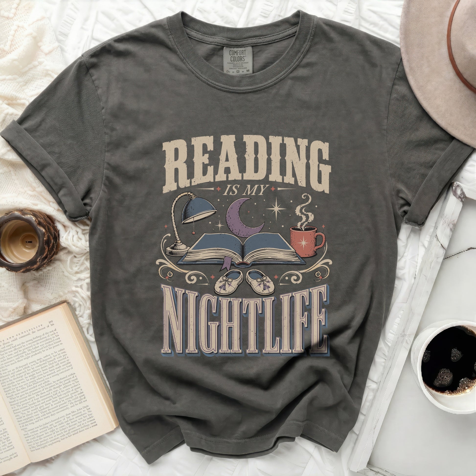 Reading is my nightlife graphic t-shirt with book, lamp, and moon design.
