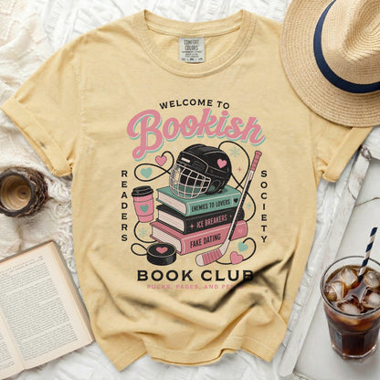 Yellow t-shirt with "Welcome to Bookish Readers Society" and book-themed icons.