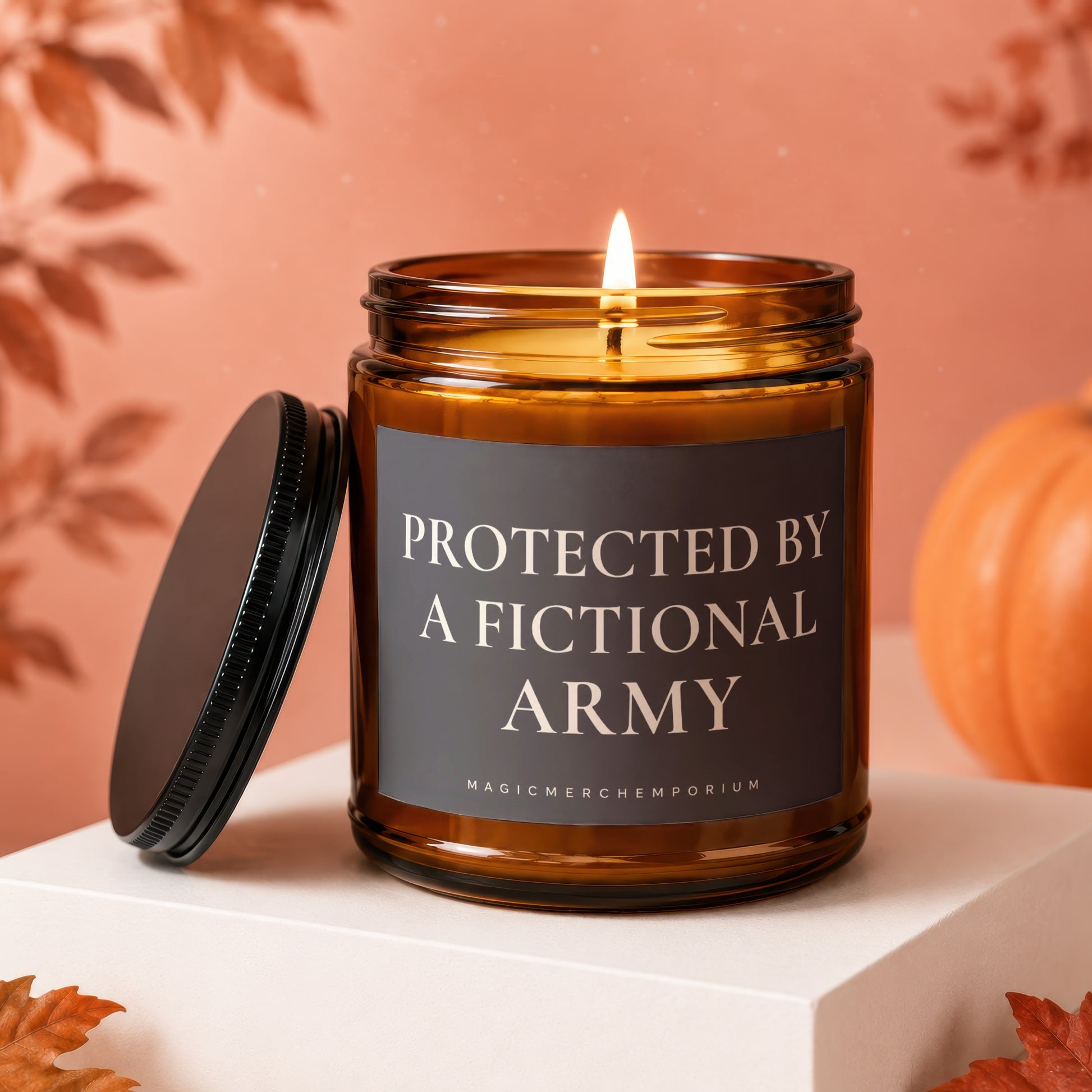Amber jar candle with lit flame and lid off, reading "Protected By A Fictional Army".