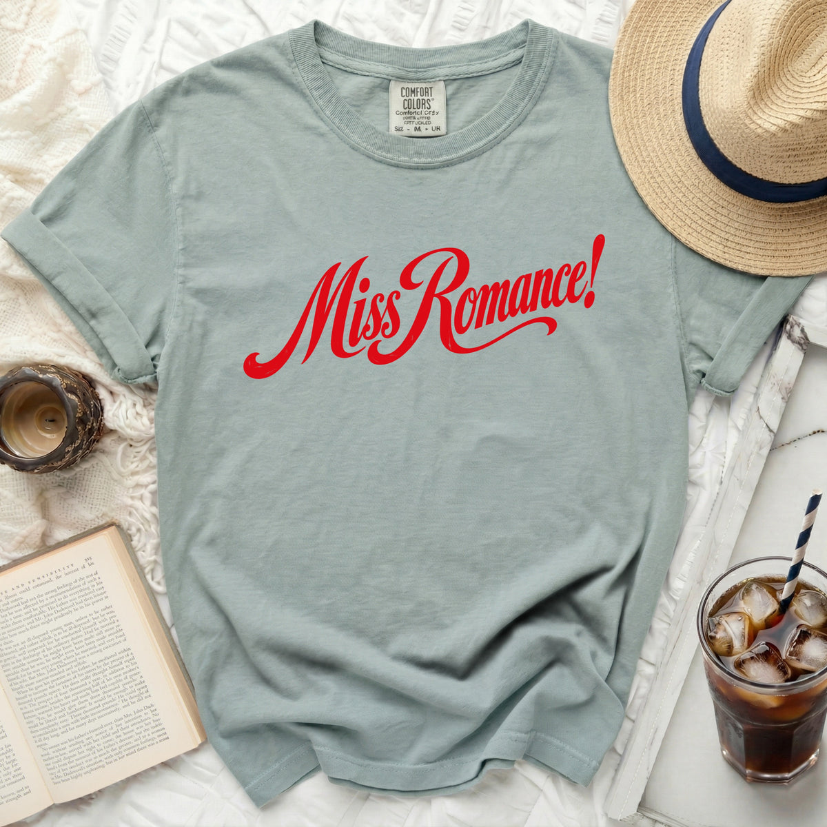 Light blue Comfort Colors t-shirt with red "Miss Romance!" graphic.