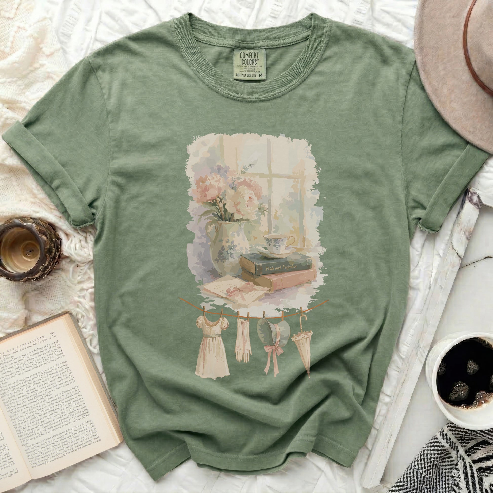 Green t-shirt with a watercolor print of a vintage still life.