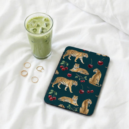 Dark teal case with tiger and cherry pattern, next to a matcha latte and rings.