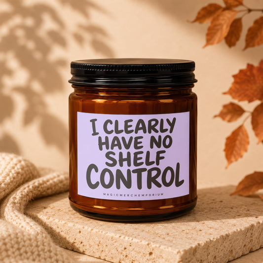 Amber candle with black lid and lavender label saying "I CLEARLY HAVE NO SHELF CONTROL".